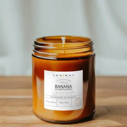 Banana Coconut Citrus candle in an 8oz amber jar by Lux Candles & Melts, delivering a tropical scent experience.