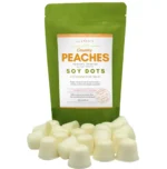 Country Peaches wax melt dots displayed in front of a rice paper stand-up pouch from Lux Candles & Melts.