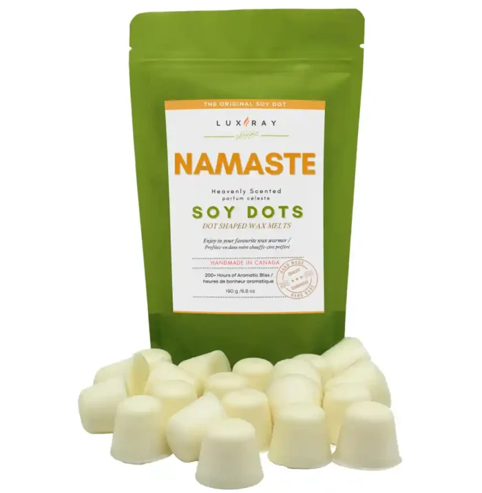 Namaste wax melt dots displayed in front of a rice paper stand-up pouch from Lux Candles & Melts.