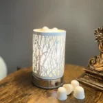 Soy wax dots in a decorative warmer placed on an end table, adding cozy ambiance to the room.