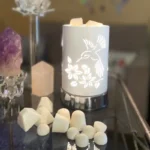 Lux Candles & Melts soy dots and wax melts in a warmer, creating a cozy and aromatic environment.