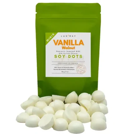 Vanilla Walnut mini soy wax melt dots in front of a rice paper stand-up pouch by Lux Candles & Melts.