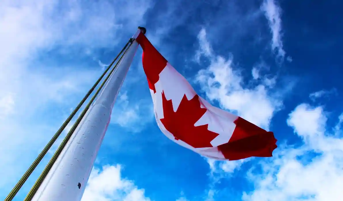 A vibrant image of the Canadian flag waving in the breeze, symbolizing pride and unity.